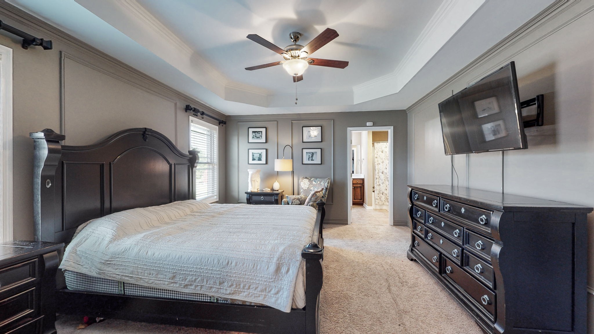 2870 Canoe Branch Road Lebanon, TN 37087 - Photo 21 of 45 a bedroom with a large bed and a chandelier