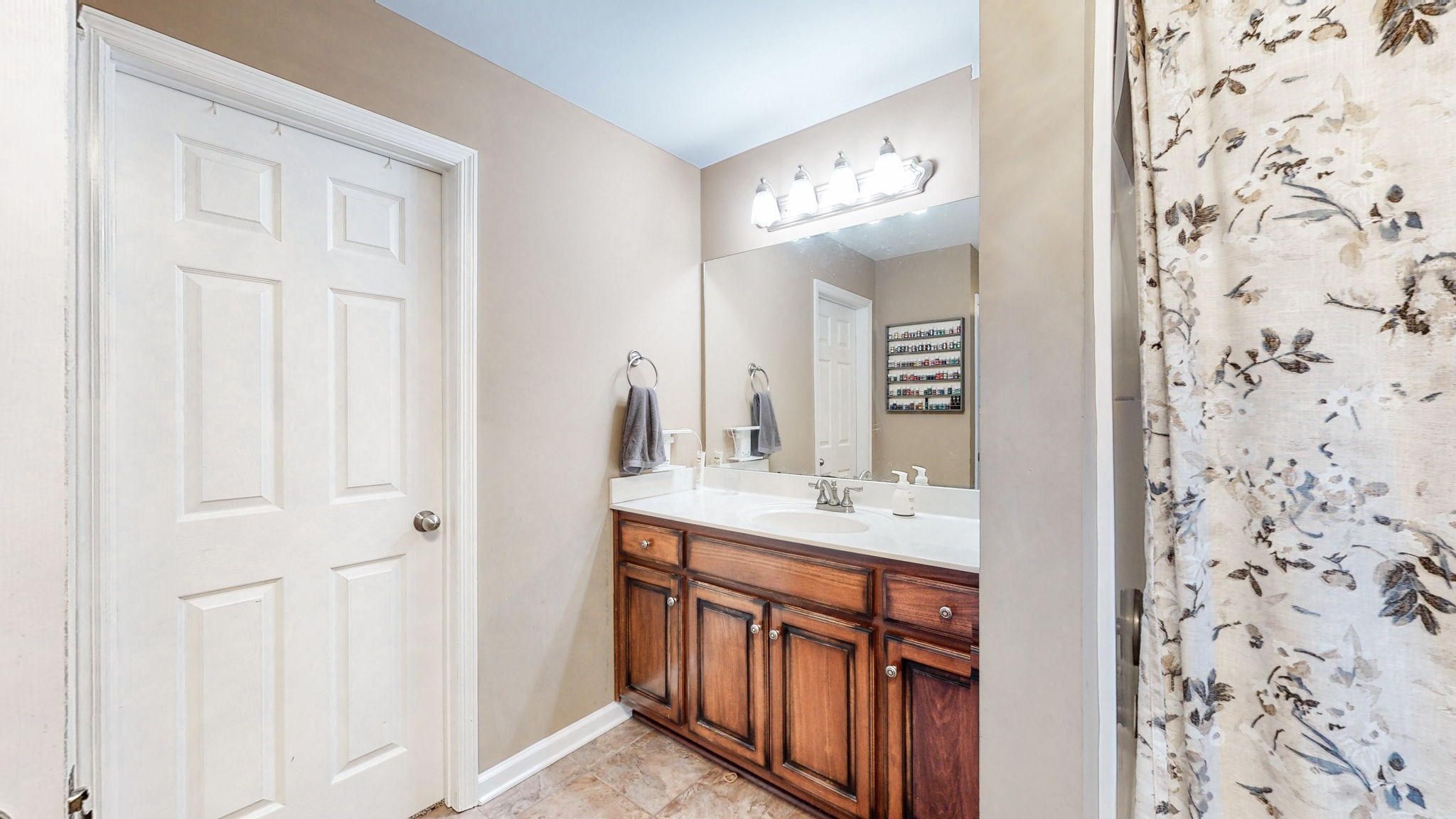 2870 Canoe Branch Road Lebanon, TN 37087 - Photo 25 of 45 a bathroom with a sink a mirror a vanity and a shower