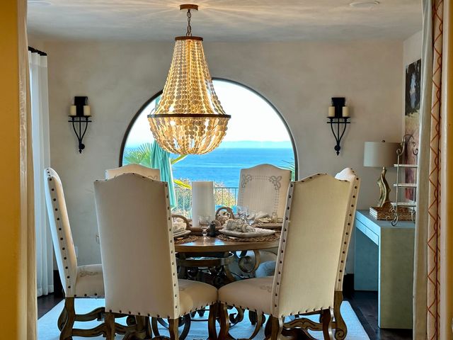 a dining room with furniture a chandelier and wooden floor