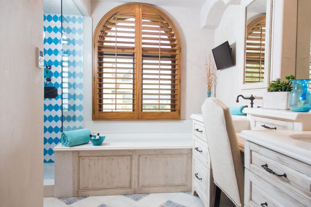 a bathroom with a tub sink and window