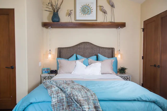 a bedroom with a bed and painting on the wall