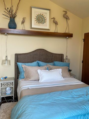 a bedroom with a bed and a potted plant