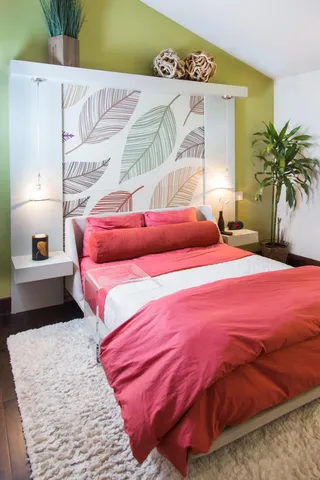 a bedroom with a bed and a couch