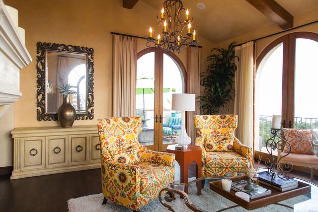 a living room with furniture and a large mirror