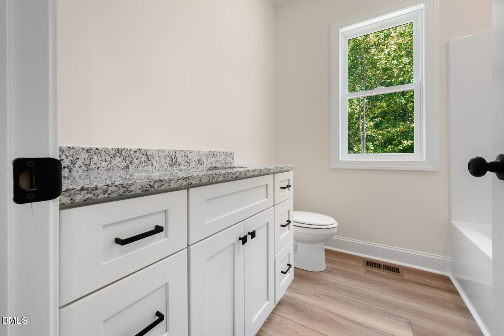2251 Peachtree Hills Road Spring Hope, NC 27882 - Photo 25 of 46 a view of bathroom with a toilet sink and a window