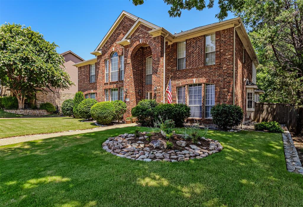 9301 Nottingham Court Rowlett, TX 75088 - Photo 2 of 39 Brick exterior featuring arched entry, bay windows, and a gabled roofline