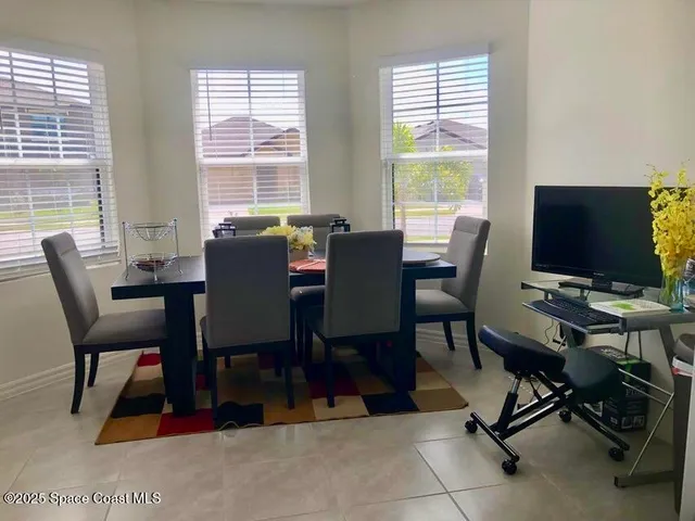a living room with chairs and a fireplace