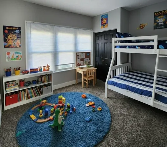 a living room with furniture and a book shelf