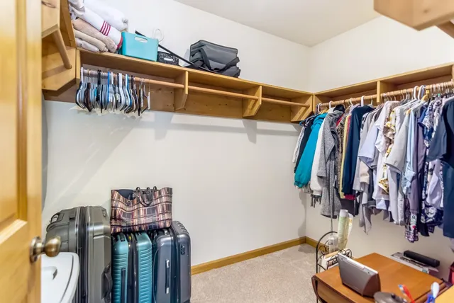 a living room with furniture a fireplace and a floor to ceiling window