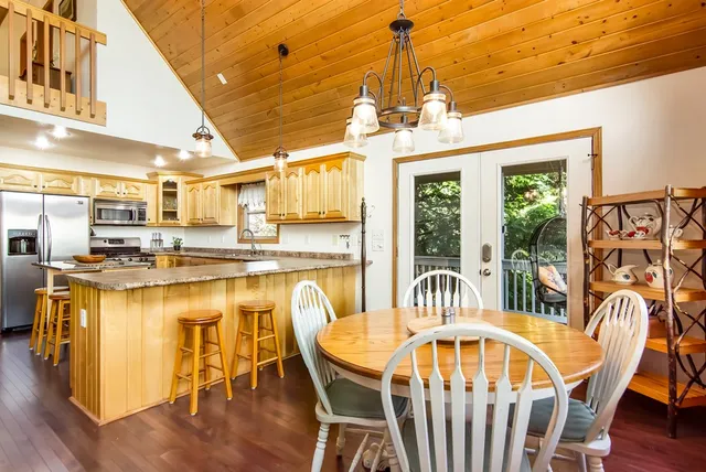 a kitchen with stainless steel appliances granite countertop a sink a stove and a refrigerator