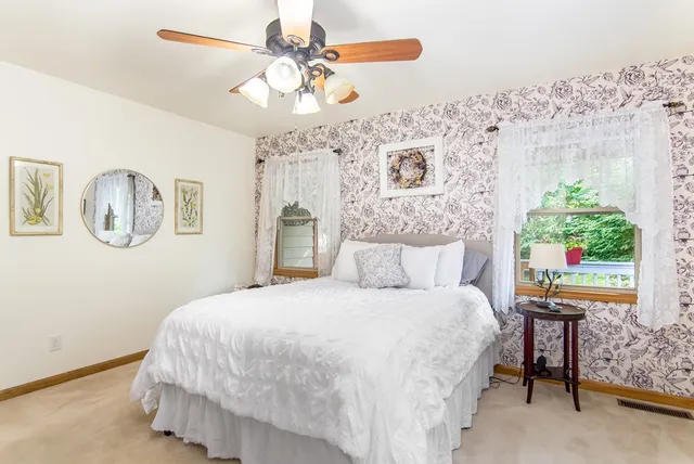 a bedroom with a large bed and a chandelier