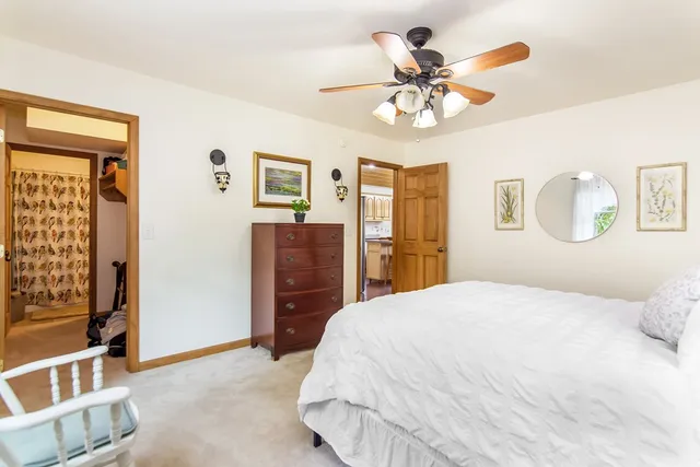 a bathroom with a granite countertop sink mirror vanity and toilet