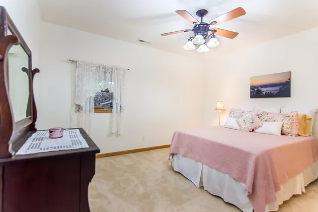 a bedroom with a bed and a dresser