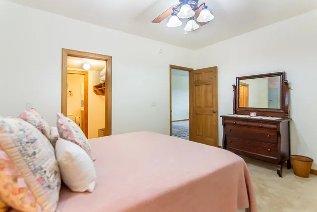 a bathroom with a sink a toilet a large mirror and shower curtain