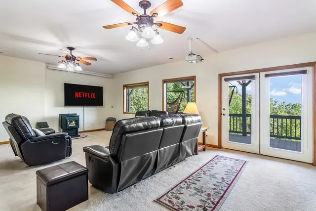 a living room with furniture and a chandelier