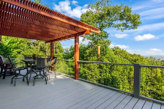 a view of a balcony with furniture and a floor to ceiling window