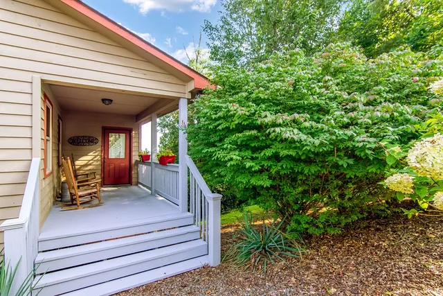 a view of a balcony with couches and wooden floor