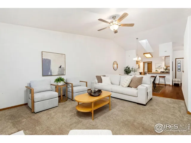 a living room with furniture a rug and a chandelier