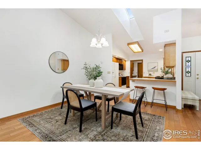 a dining room with furniture and wooden floor