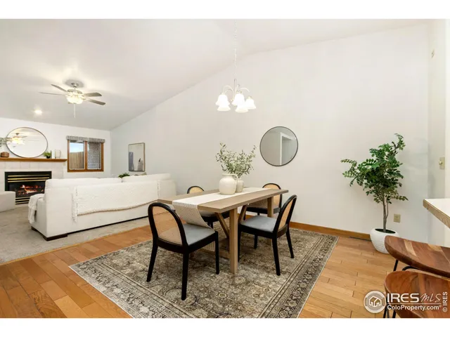 a living room with furniture a dining table and a fireplace