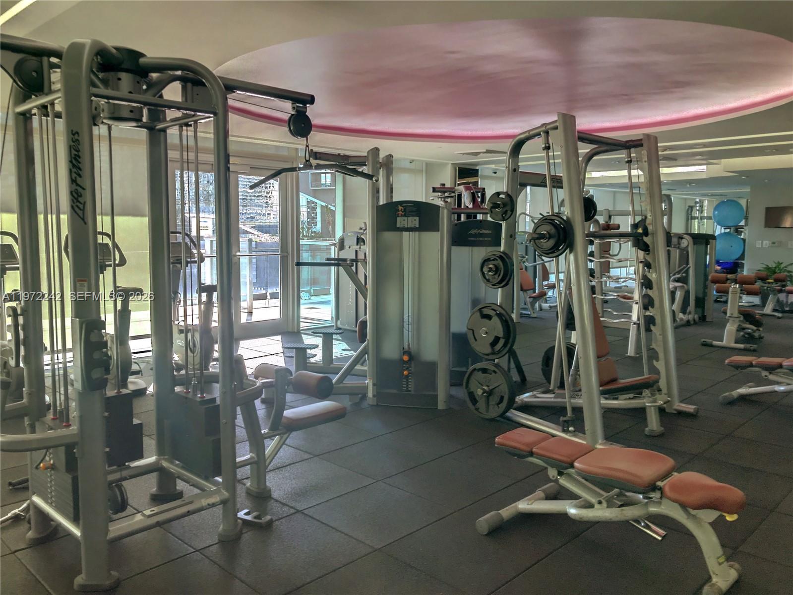 55 Southeast 6th Street, Unit 1201 Miami, FL 33131 - Photo 15 of 26 a room with gym equipment