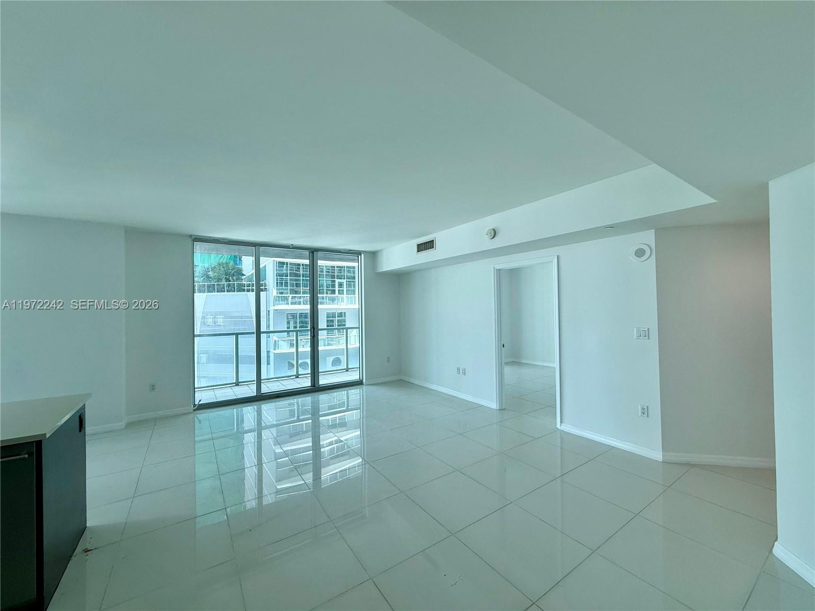 55 Southeast 6th Street, Unit 1201 Miami, FL 33131 - Photo 2 of 26 a view of an empty room with a window