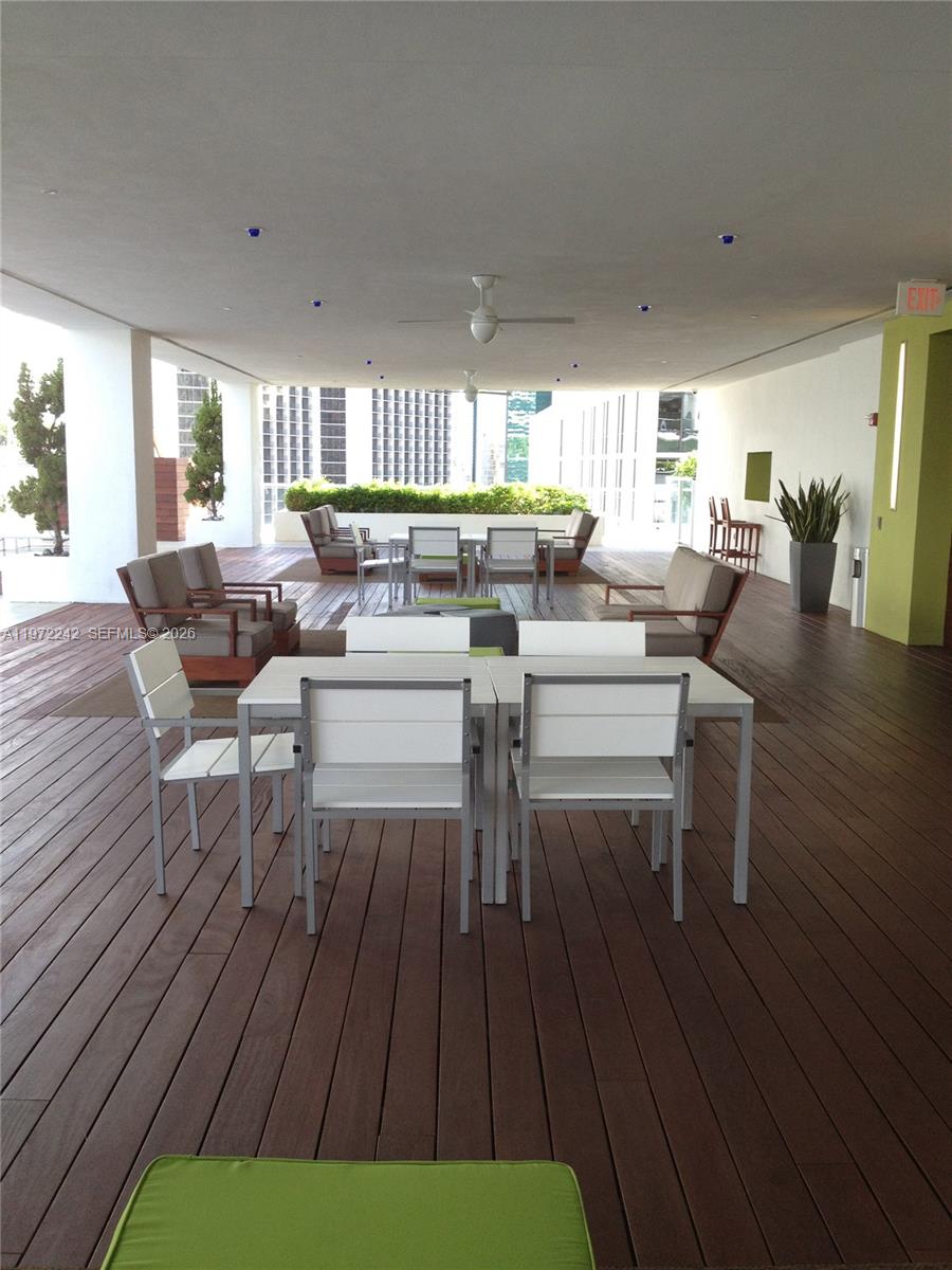 55 Southeast 6th Street, Unit 1201 Miami, FL 33131 - Photo 24 of 26 a living room with fireplace furniture and a wooden floor