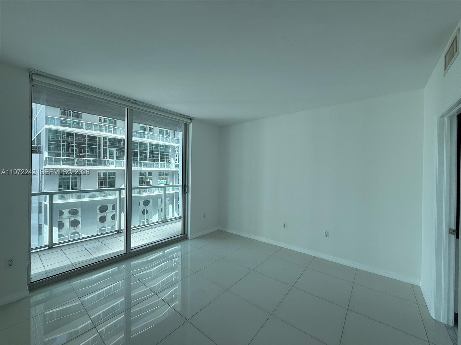 55 Southeast 6th Street, Unit 1201 Miami, FL 33131 - Photo 3 of 26 a view of an empty room with a window