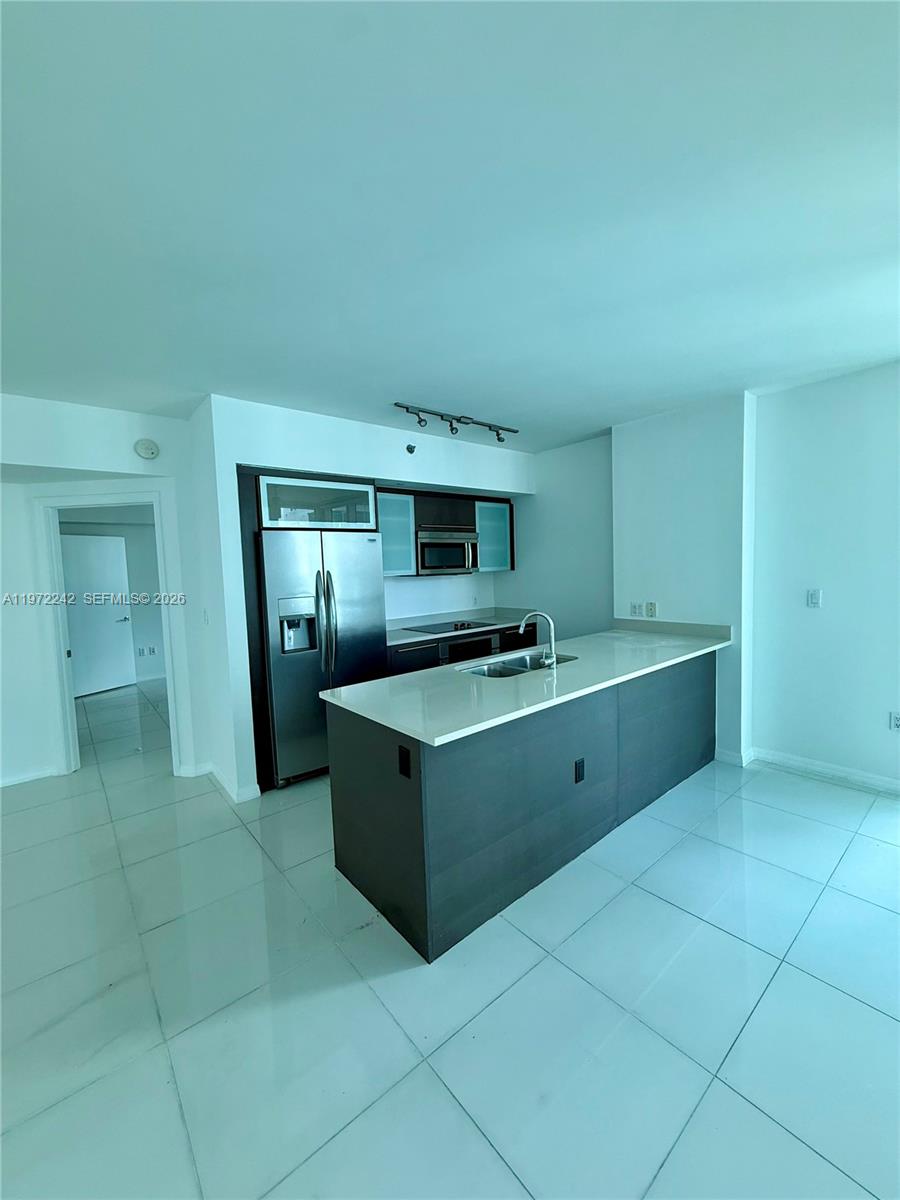 55 Southeast 6th Street, Unit 1201 Miami, FL 33131 - Photo 4 of 26 a kitchen with stainless steel appliances granite countertop a sink and cabinets