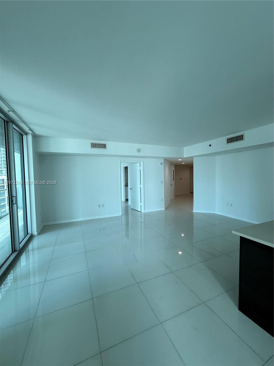 55 Southeast 6th Street, Unit 1201 Miami, FL 33131 - Photo 5 of 26 a view of a livingroom with an empty space and a window