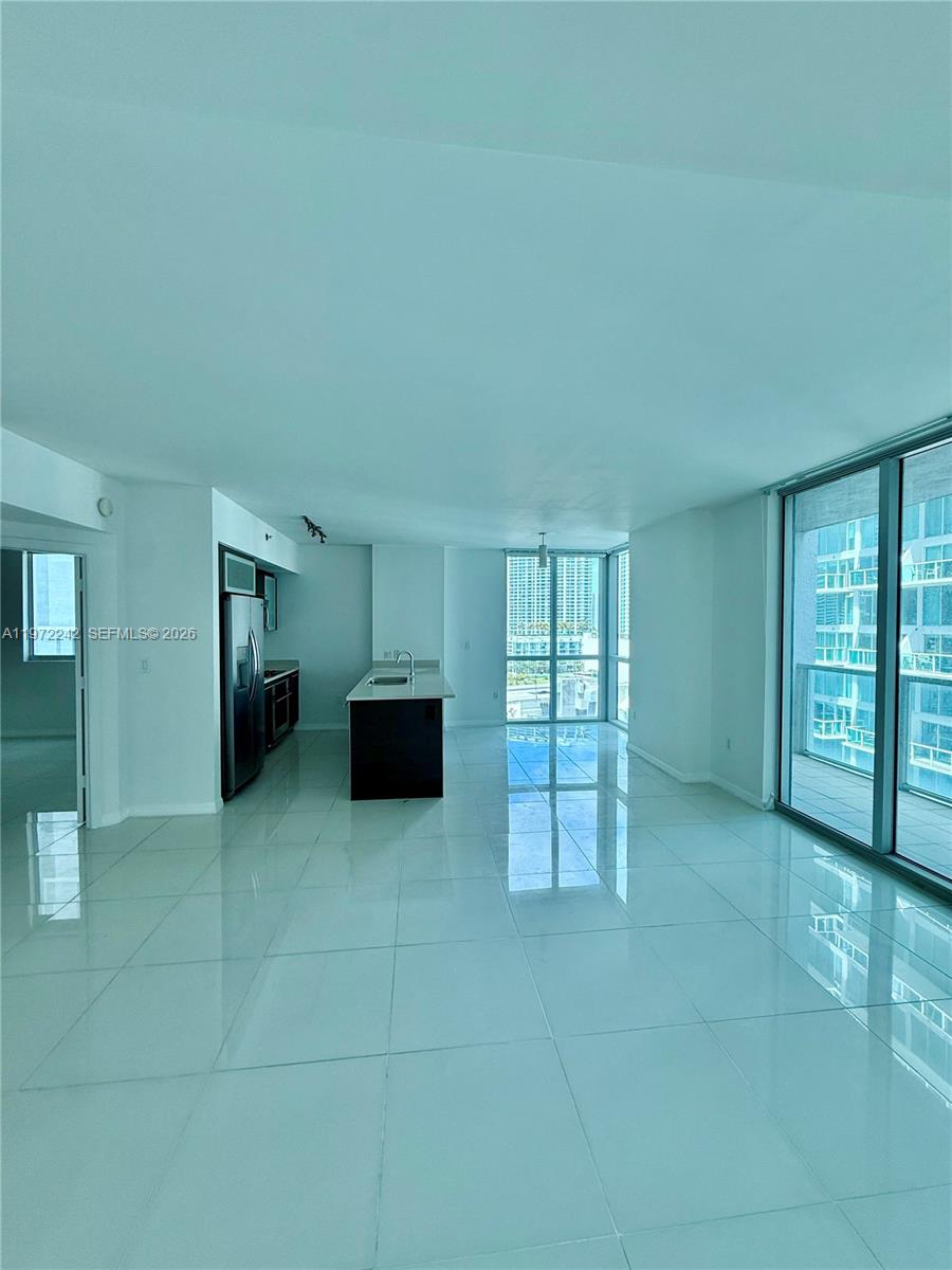 55 Southeast 6th Street, Unit 1201 Miami, FL 33131 - Photo 6 of 26 a room with furniture and large window