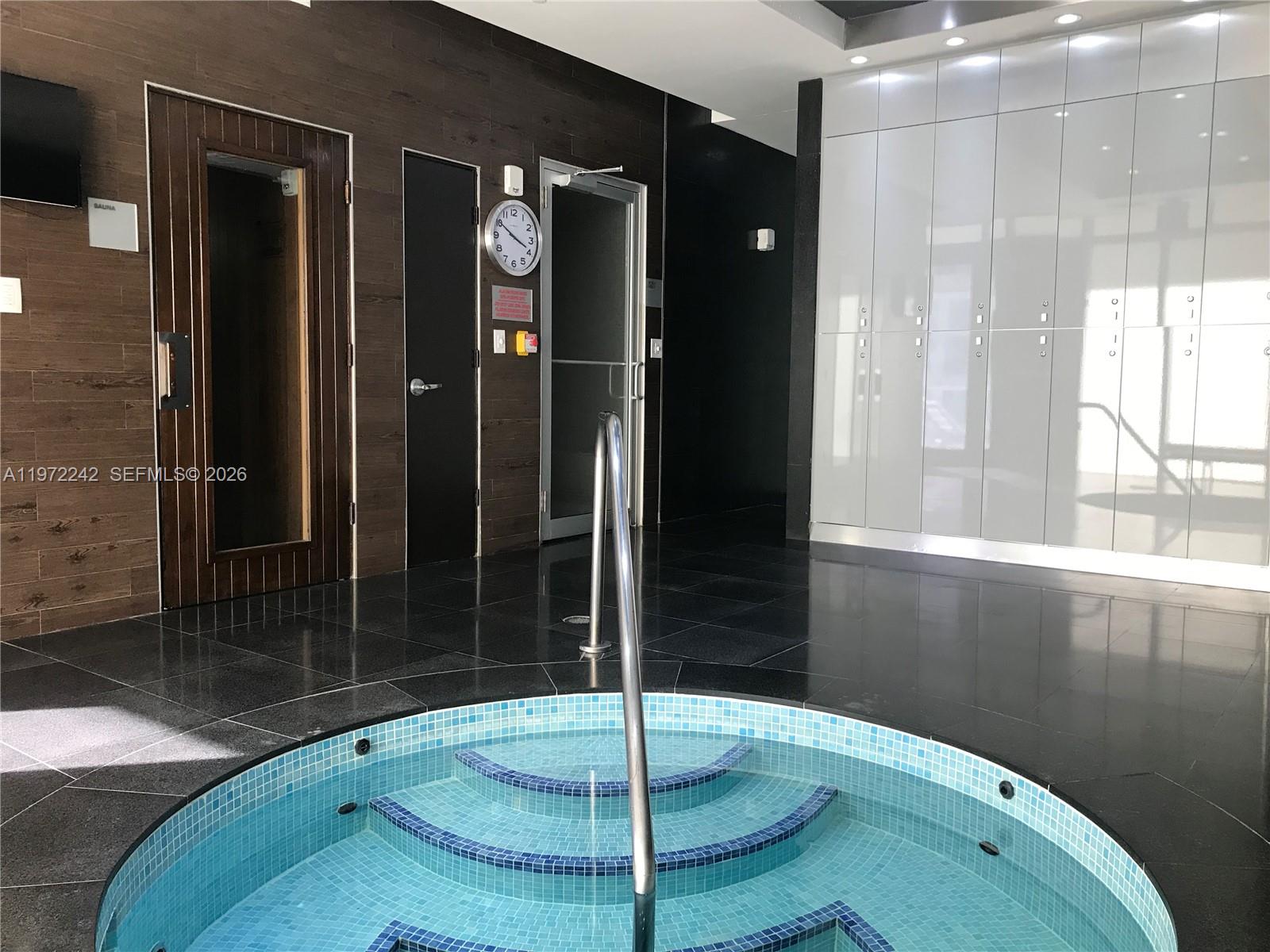 55 Southeast 6th Street, Unit 1201 Miami, FL 33131 - Photo 9 of 13 a bathroom with a shower