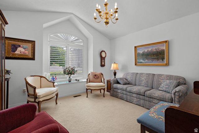 166 South Ridgeview Drive Orem, UT 84058 - Photo 6 of 38 Vaulted ceiling with a brass chandelier, arched window with plantation shutters, and a wall-mounted clock