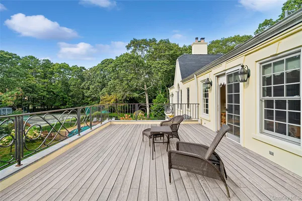 a view of balcony with chairs and wooden floor