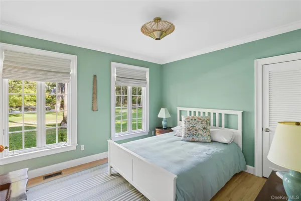 a bed sitting in a bedroom next to a window