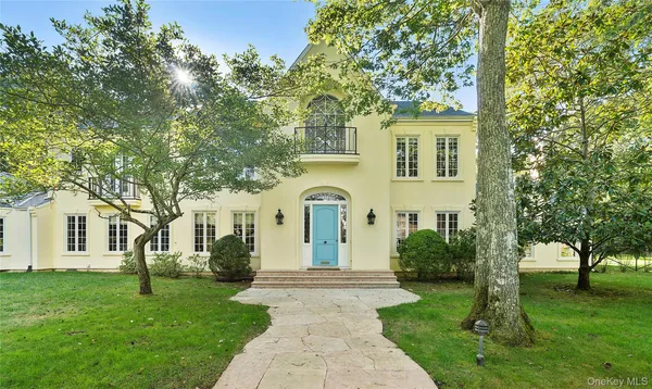 a front view of a house with a garden