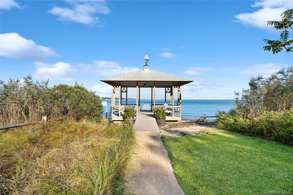 a view of a patio with a table and chairs under an umbrella