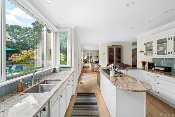 a large kitchen with granite countertop a large window and a sink
