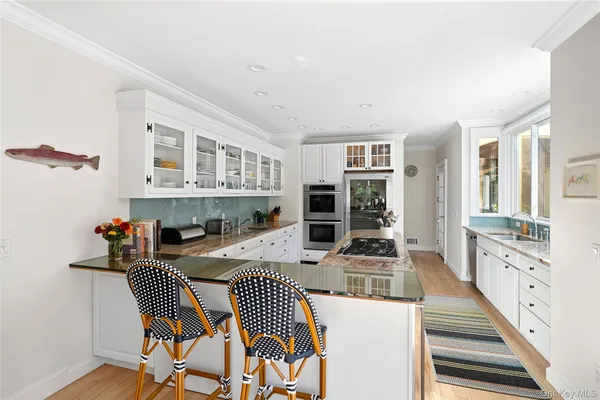 a living room with furniture a flat screen tv and a floor to ceiling window