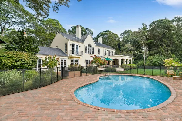 a view of a house with swimming pool and a yard