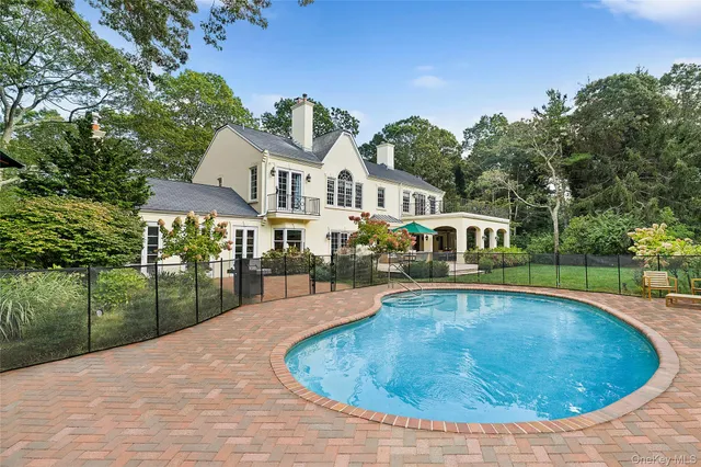a view of a house with swimming pool and a yard