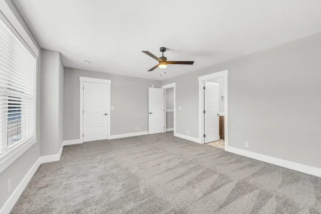 wooden floor in an empty room with a ceiling fan