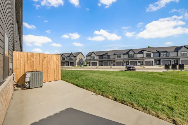 a view of a house with a big yard and large trees