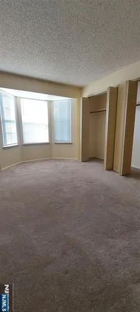 a view of an empty room and a window