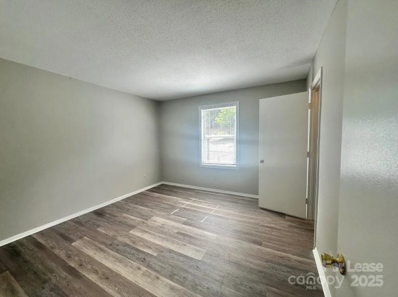 1428 Nottingham Road Kannapolis, NC 28081 - Photo 11 of 12 an empty room with wooden floor and windows