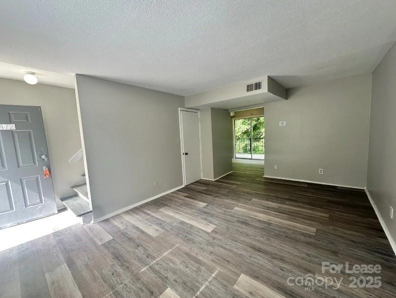 1428 Nottingham Road Kannapolis, NC 28081 - Photo 2 of 12 a view of an empty room with wooden floor and a window
