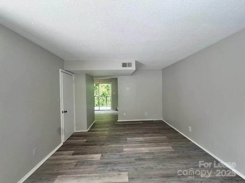 1428 Nottingham Road Kannapolis, NC 28081 - Photo 3 of 12 a view of an empty room with wooden floor and a window