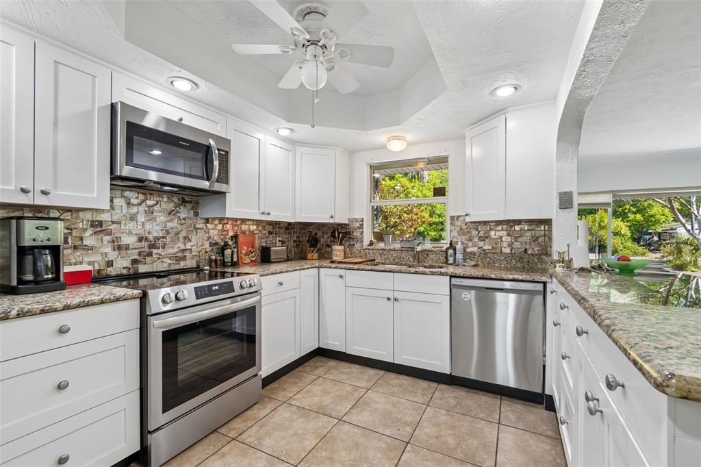 6226 8th Avenue South Gulfport, FL 33707 - Photo 11 of 46 a kitchen with stainless steel appliances granite countertop a sink and cabinets