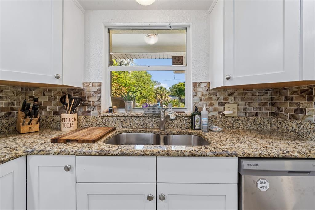 6226 8th Avenue South Gulfport, FL 33707 - Photo 12 of 46 a kitchen with granite countertop a sink and a stove