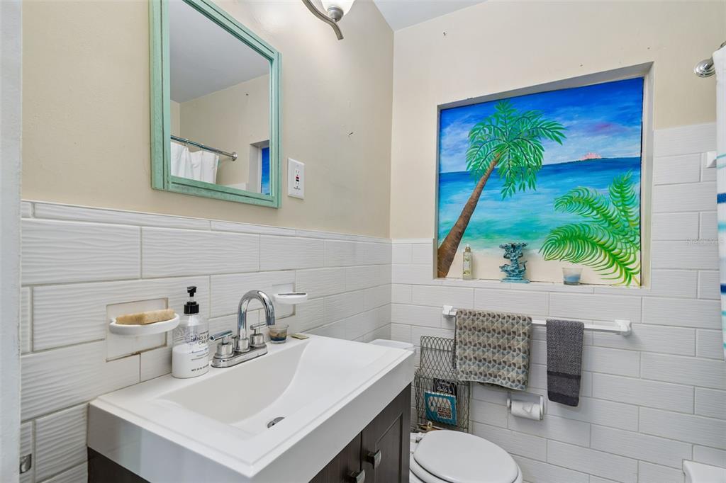 6226 8th Avenue South Gulfport, FL 33707 - Photo 27 of 46 a bathroom with a toilet a sink and a mirror